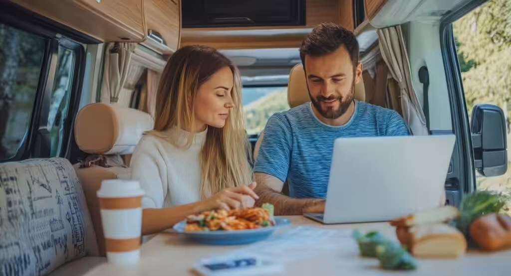 couple looking at a laptop in their motorhome