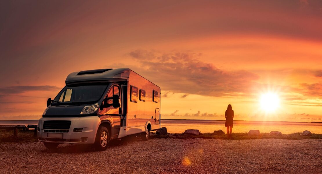 Woman on a Beach with a Motorhome