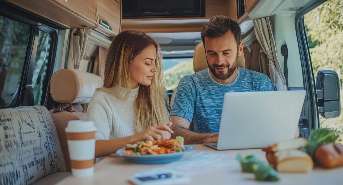 couple looking at a laptop in their motorhome